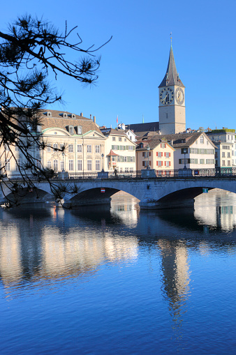 View across the Limmat to the church of St. Peter in Zurich. St. Peter is the church with the largest clockface in Europe.