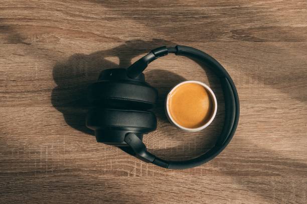 istock Coffee and a headset on a wooden table 1600594964