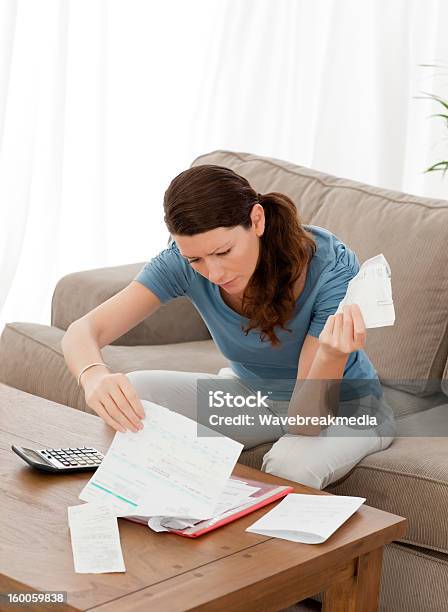 Pretty Woman Looking At Her Financial Debts Stock Photo - Download Image Now - Adult, Adults Only, Beauty