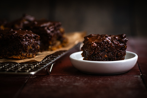 moist, juicy, fresh chocolate cake from the oven in moody, atmospheric, dark setting