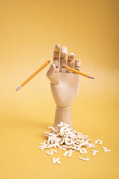 istock Wooden hand with a broken pencil and wooden letters. 1600611468