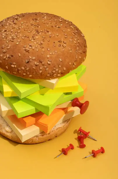 Photo of hamburger and fries made from lego bricks on color background, plastic concept photo, junk food