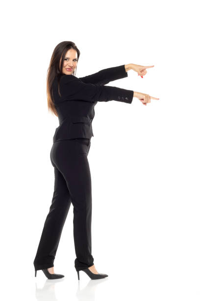 istock Smiling businesswoman pointing with both hands on a white background 1600625409