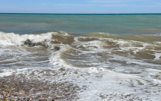 istock Waves at Pebble stone beach. Sea beach shore with waves in ocean. 1600642400