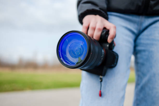 istock DSLR camera with broken lens filter. Cracked photo-filter 1600642447