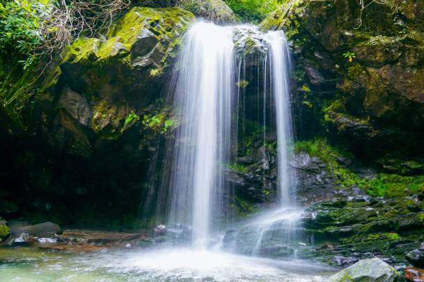 istock Large rock in front of a beautiful cascading Grotto waterfall 1600644089