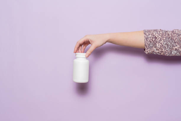 istock White plastic bottle in female hand. Packaging for pills, capsules or supplements. 1600648984