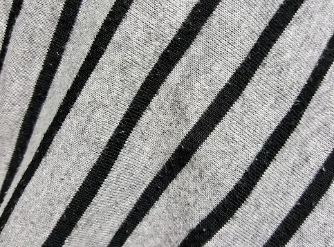 a photography of a zebra's stripes are black and white, a close up of a zebra's stripes on a white and black shirt.