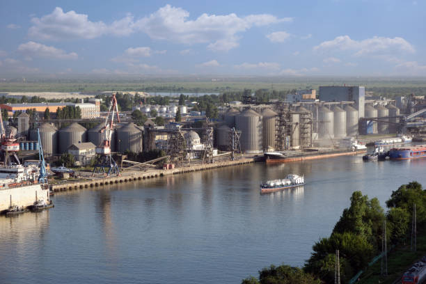 Large granary or elevator near the river port. Industrial area outside the city.
