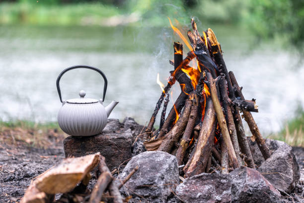 istock Small kettle is heated on a bonfire, outdoor recreation concept. 1600680640