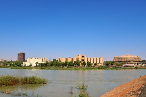 Niamey, Niger: cityscape and the Niger River and the city seen from John F. Kennedy Bridge - From the left, Housing Ministry, Radisson Blu Hotel, Congress Palace, BCEAO, Sonidep, Hotel Gaweye, Ministry of Mines and Energy, avenue François Mitterrand / Boulevard de la Republique.