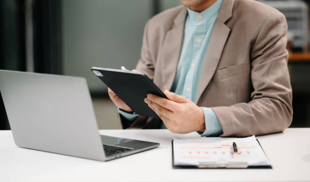 istock Businessman s hands typing on smartphone, tablet and laptop keyboard computer, typing, online in office 1600685546