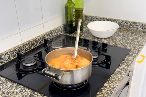 istock Cooking shrimp on stove in kitchen. Shrimp boiled in a pot on fire. 1600688318