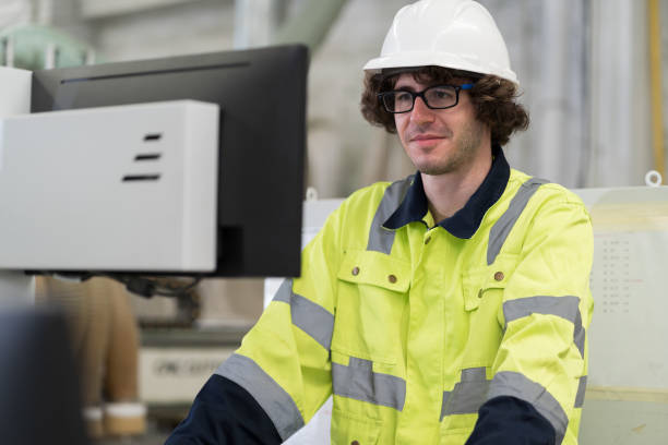 istock Male engineer worker working with desktop computer in industry factory. Male technician using computer control and maintaining machine in the factory 1600693247