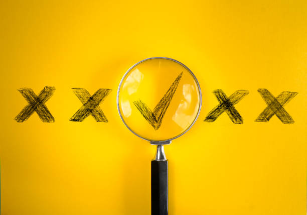 istock Magnifying glass enlarging the correct chice or check mark on yellow background. Business concept,idea,right choice,quality control and Approval and Contract assignment 1600699231