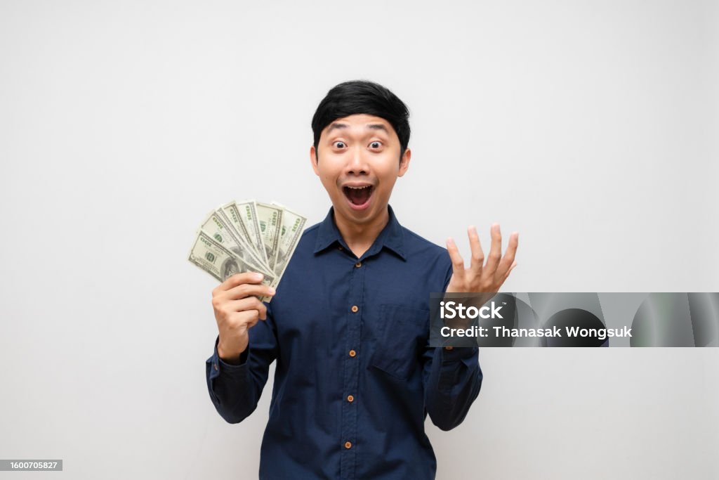 Asian man feels shocked about earn money in his hand isolated 30-34 Years Stock Photo