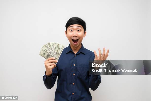 Asian Man Feels Shocked About Earn Money In His Hand Isolated Stock Photo - Download Image Now