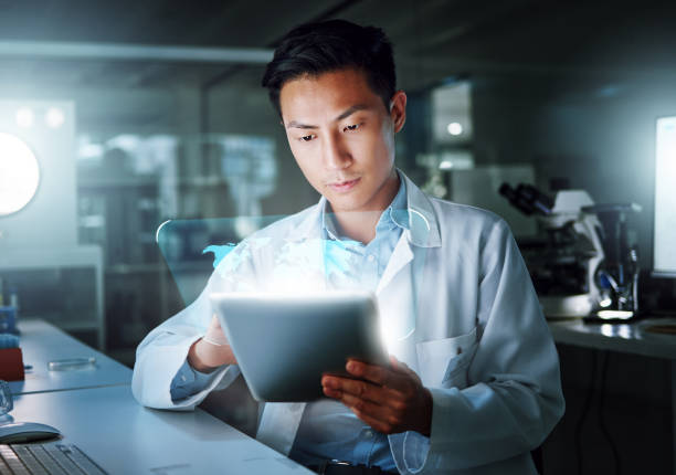 istock Tablet, hologram and scientist with digital innovation, global data and 3d overlay in laboratory. Asian man, doctor and information technology for futuristic medical research with healthcare study 1600719551