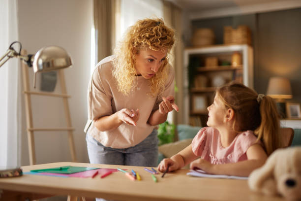 istock Mother scolding her daughter while helping her with homework at home 1600724001