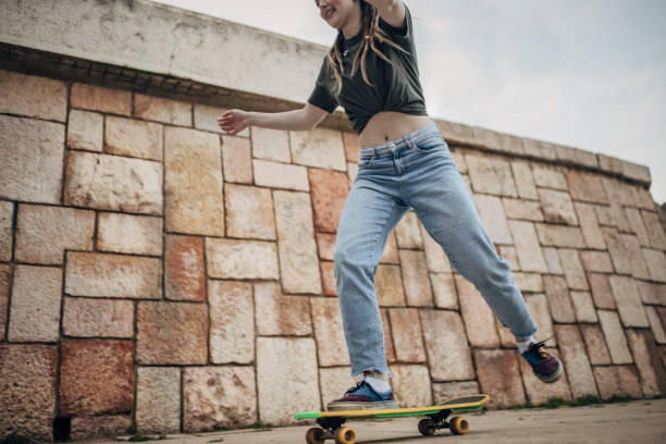istock Young woman riding skateboard 1600734860
