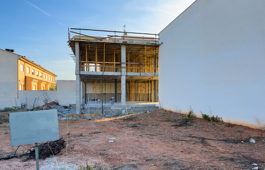 House under construction. Townhouse on Construction site. Luxury villa under construction near beach of Mediterranean sea. Construction of modern house near coastline. Home renovation near ocean.