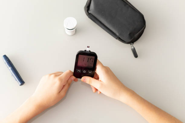 istock Teenager's hands using glucometer to measure insulin level 1600743702
