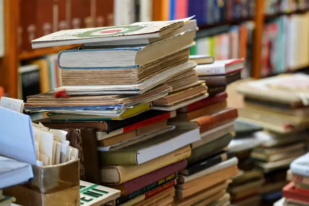 Photo of Stacks of many old used books displayed at local antiquarian bookshop