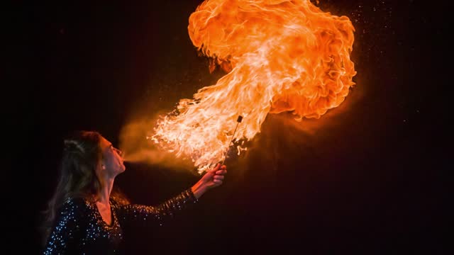 Woman breathing fire in slow motion