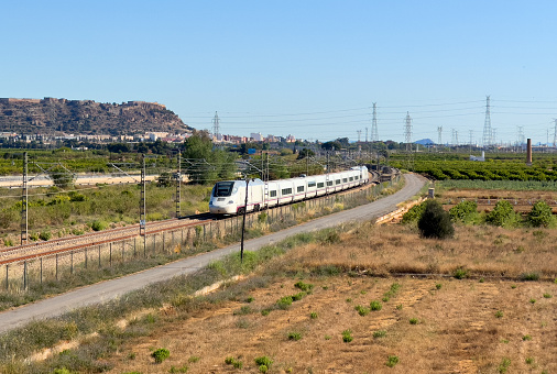 Train on railway. High-speed train in motion on Valencia  Barcelona high-speed railroad. European passenger train on railway. High-speed train. Spanish National Rail Network.