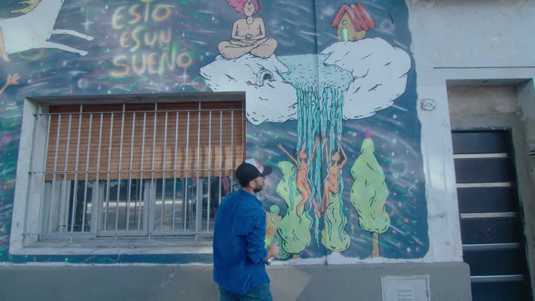 Street Artist Drawing Surreal Graffiti Outdoors in the City