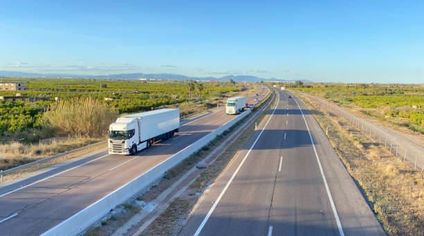 istock Semi truck with Semi-trailer driving along highway. 1600785155