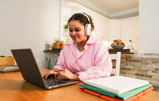 istock Girl using laptop computer from home while studying at college homework project - Back to school and lifestyle concept -Focus on face 1600797415