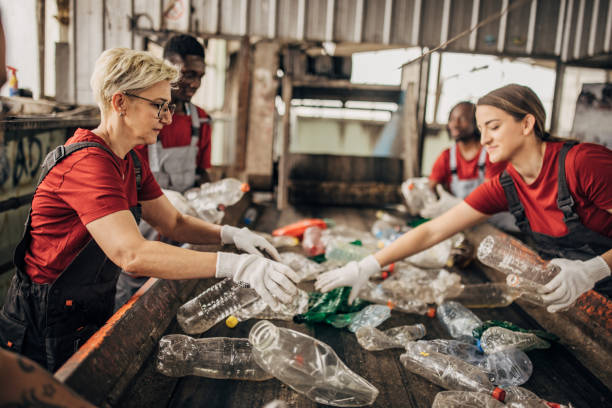 istock Group of workers at the recycling centre sorting plastic waste ad preparing for recycling 1600799766