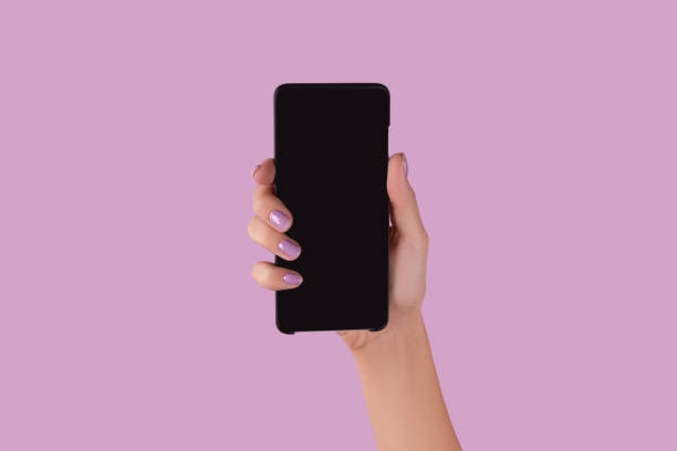 istock Womans hand with lavender manicure holding smartphone with blank screen 1600825099