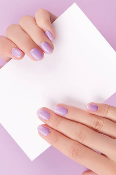 istock Female hands with trendy manicure holding postcard 1600831515