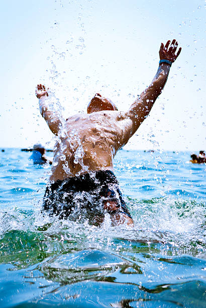 istock man falling in sea splashing water 160083198