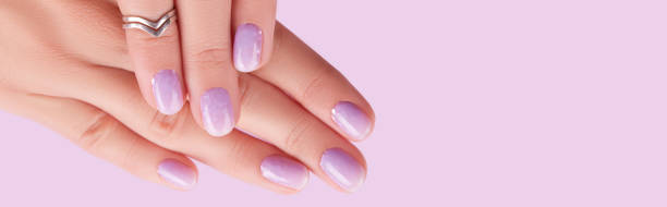 istock Womans hands with trendy lavender manicure. Spring summer nail design 1600832104