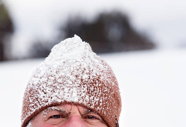 Man Wearing Snow Covered Cap stock photo