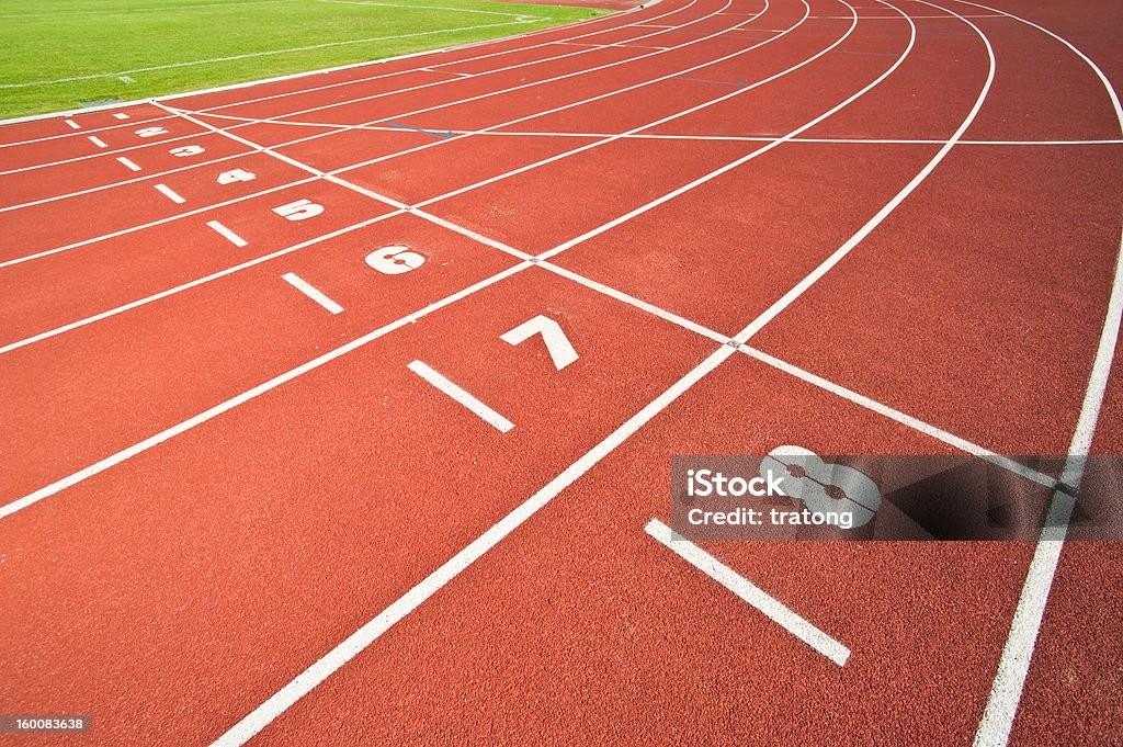 Running Track Numbered lanes on a running track. Backgrounds Stock Photo