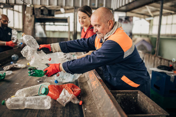 istock Group of workers at the recycling centre sorting plastic waste ad preparing for recycling 1600836520