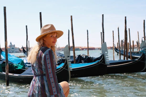 istock Female tourist at Venetian gondolas dock 1600837617