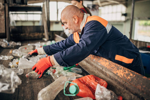 istock Group of workers at the recycling centre sorting plastic waste ad preparing for recycling 1600838700