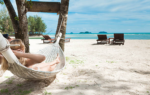 istock Blond woman asleep in a hammock. 160084373