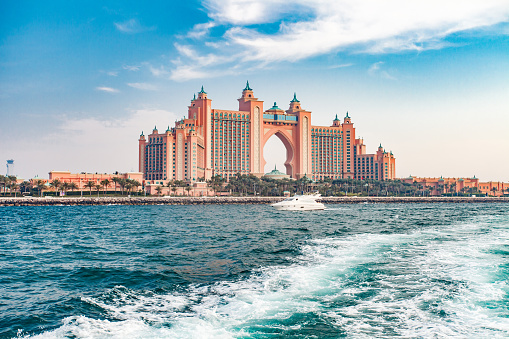 Dubai, UAE  april 11, 2023: Palm Jumeirah, Atlantis The Palm, white yacht sailing on water
