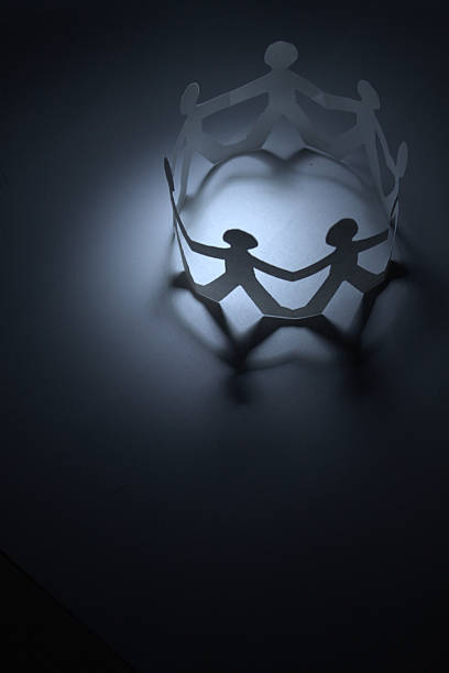 istock Circle of paper people holding hands 160085845