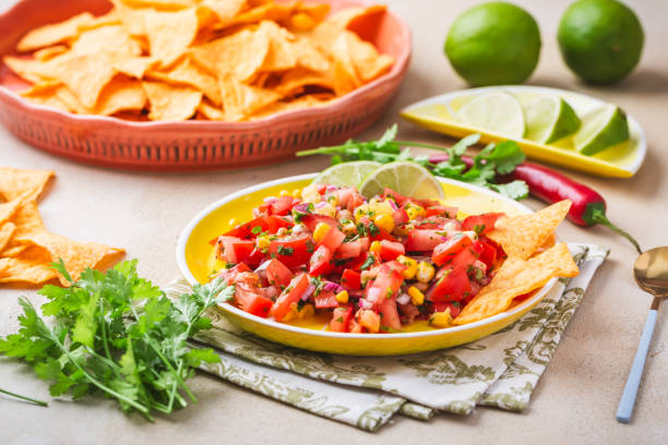 istock Tex Mex Pico de Gallo tomato salsa or salad with nacho tortilla chips. 1600862114