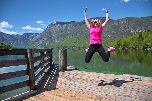 Portrait of the mature woman having fun on Bohinj lake in Slovenia