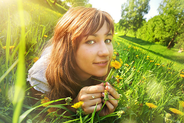 istock Young woman lying on grass 160087288