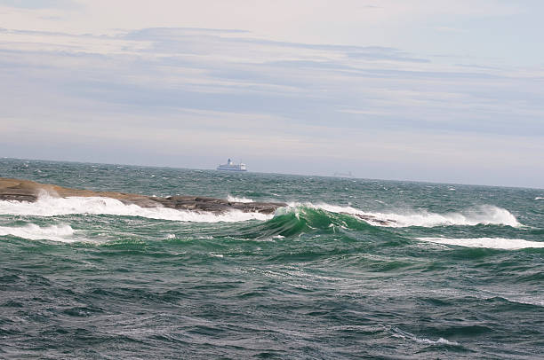 istock Big waves and ferries in background 160087331