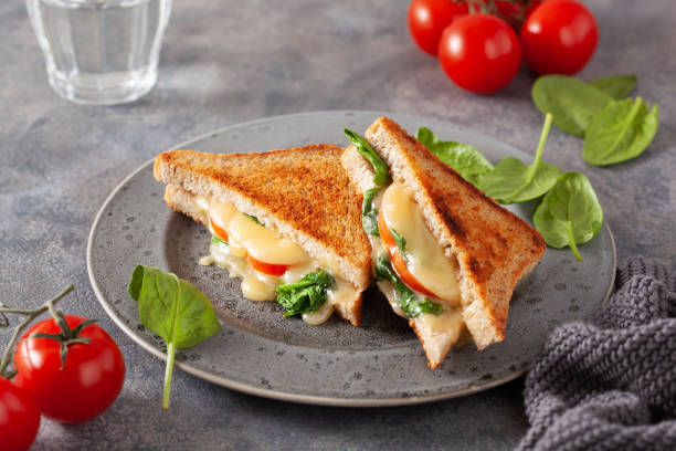 istock grilled cheese spinach and tomato sandwich on concrete background 1600885312